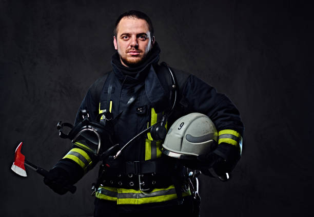 istock Firefighter dressed in uniform holds safety helmet. 954151434