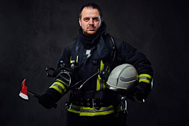 istock Firefighter dressed in uniform holds safety helmet. 954151558