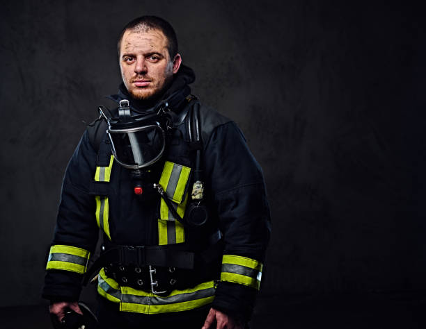 istock Studio portrait of a male dressed in a firefighter uniform. 954151770