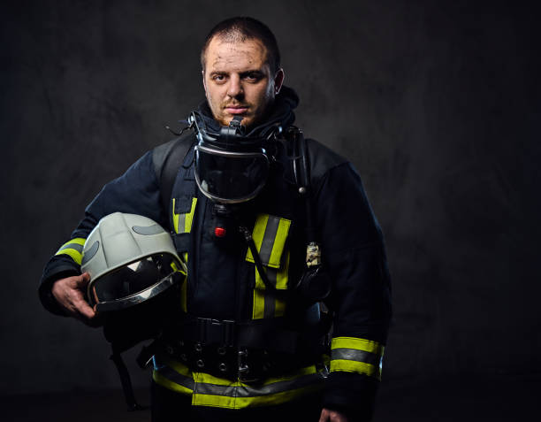 istock Firefighter dressed in uniform holds safety helmet. 954154158