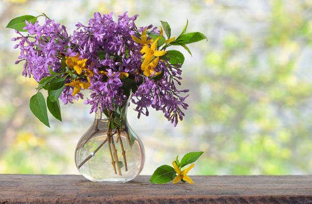istock Spring Lilac bouquet on the wooden table 954154270