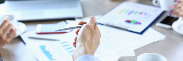 istock businessmen meet in cafe discuss documents 954154722