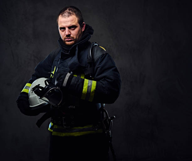 istock Firefighter dressed in uniform holds safety helmet. 954154760