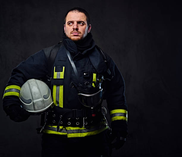 istock Firefighter dressed in uniform holds safety helmet. 954155004