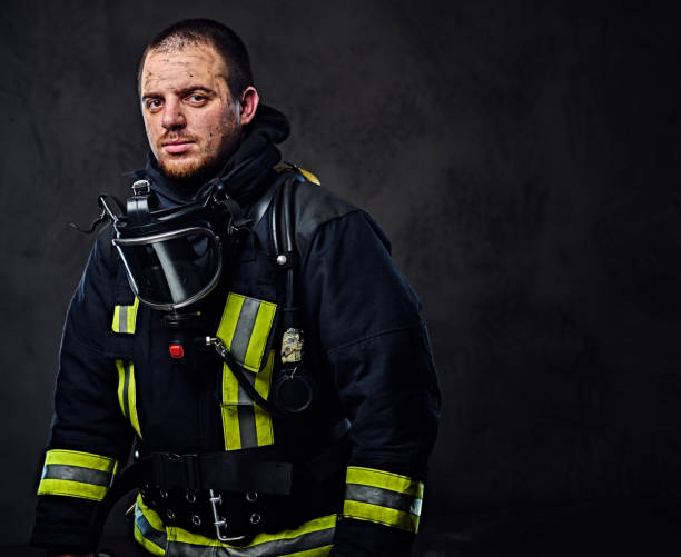 istock Studio portrait of a male dressed in a firefighter uniform. 954155322