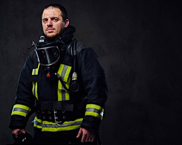 istock Studio portrait of a male dressed in a firefighter uniform. 954155768