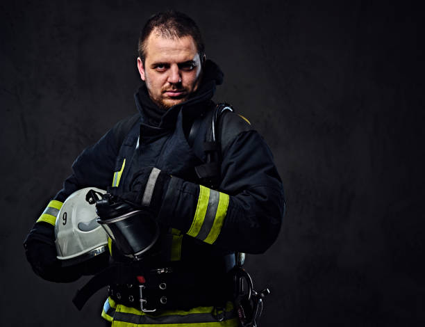 istock Firefighter dressed in uniform holds safety helmet. 954156330