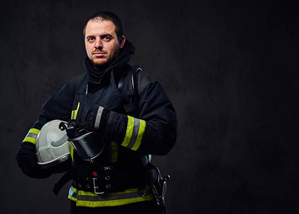 istock Firefighter dressed in uniform holds safety helmet. 954157806