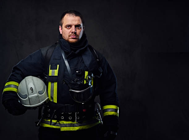 istock Firefighter dressed in uniform holds safety helmet. 954160396
