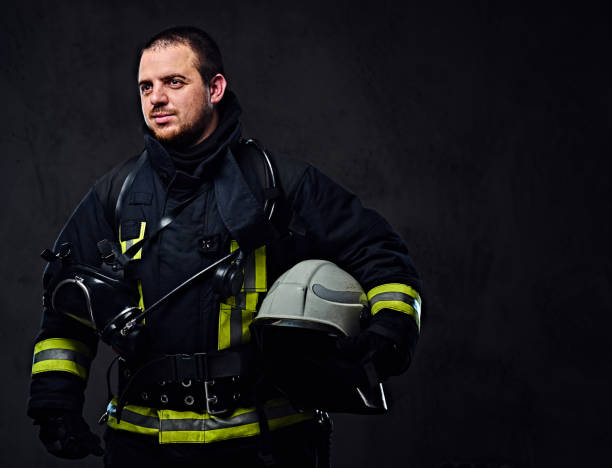 istock Firefighter dressed in uniform holds safety helmet. 954161696