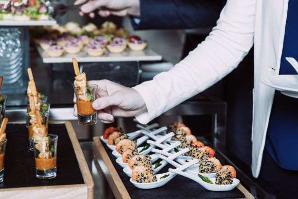 istock Cropped Woman Taking Snack from Buffet Table 954162046