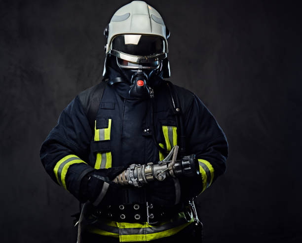 Firefighter dressed in uniform and an oxygen mask. stock photo