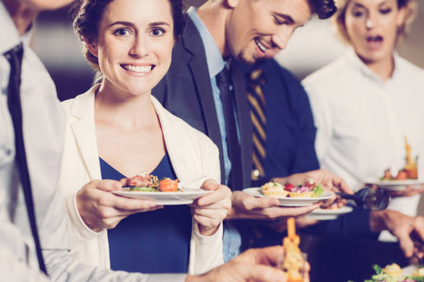 istock Smiling Business People and Snacks at Buffet Table 954162188