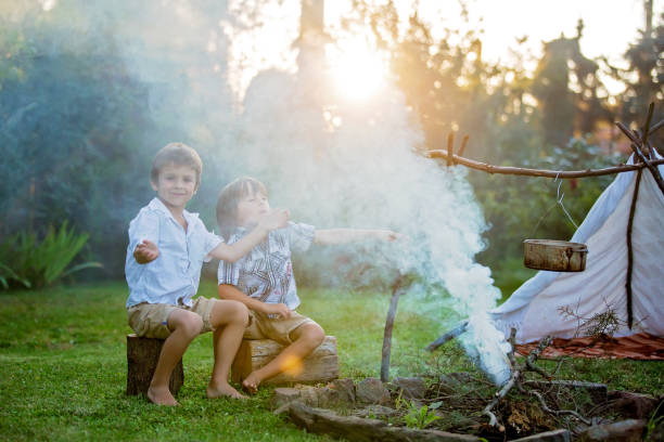 istock Two sweet children, boy brothers, camping outside summertime on sunset 954165452