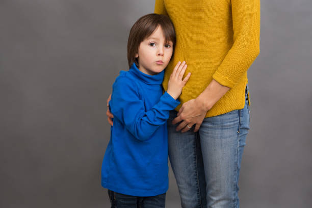 istock Sad little child, boy, hugging his mother at home, isolated image 954165764