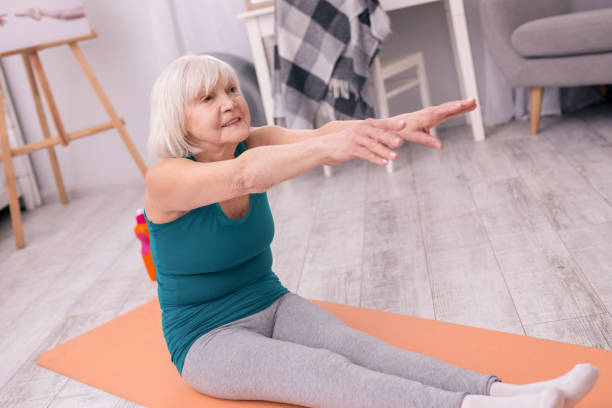 istock Athletic elderly woman carrying out stretching exercise 954165906