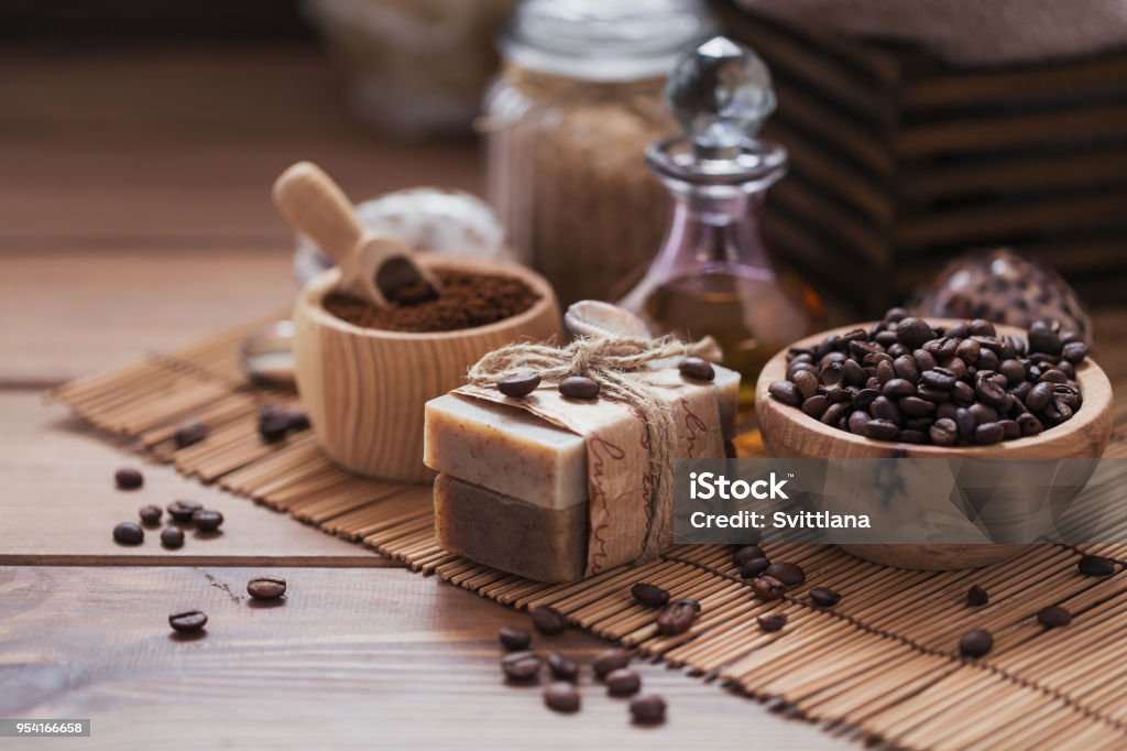 Natural handmade soap, aromatic cosmetic oil, sea salt with coffee beans Natural handmade soap, aromatic cosmetic oil, sea salt with coffee beans on rustic wooden background. Healthy skin care. Sauna and SPA concept. Soap Stock Photo