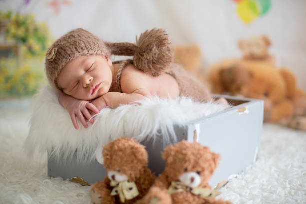 istock Cute newborn baby sleeps with a toys 954169158