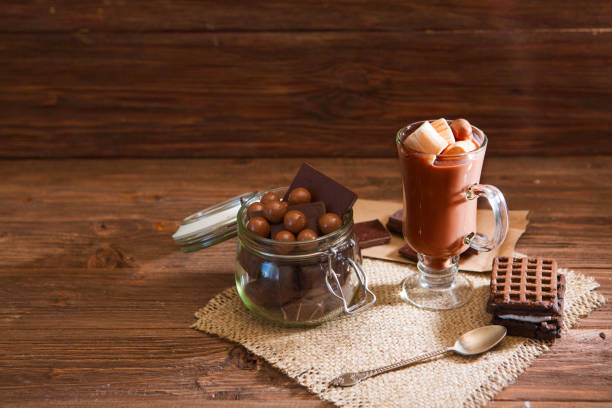 istock Chocolate cocktail with marshmallows on wooden background 954176894