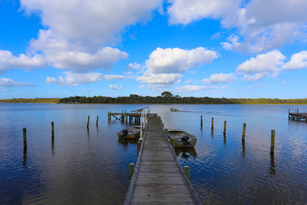 istock Boats moored at wooden pier 954177006