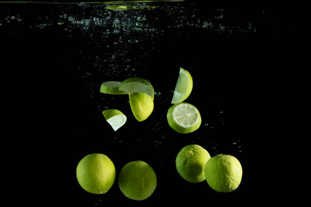 istock Fresh limes are dropped into water. 954180696