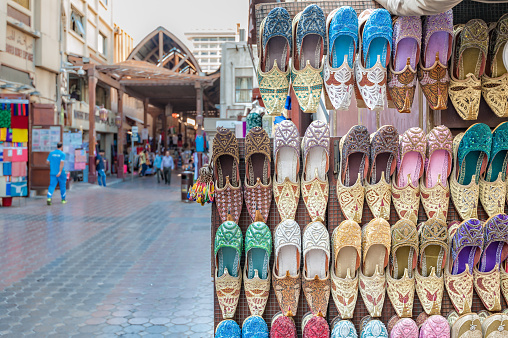 Colorful shoes on rack in souk of Dubai.
