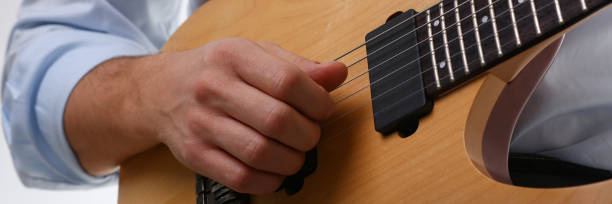 istock Male arms playing classic shape electric guitar 954191670