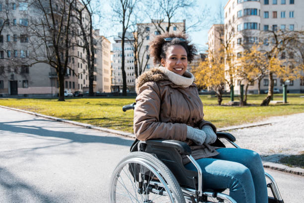 istock Disabled woman sitting in a wheelchair and looking at camera 954196968