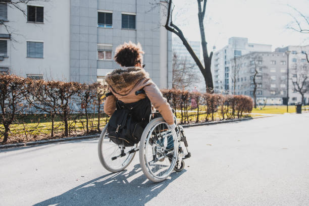 istock Disabled woman in a wheelchair in a park 954196982