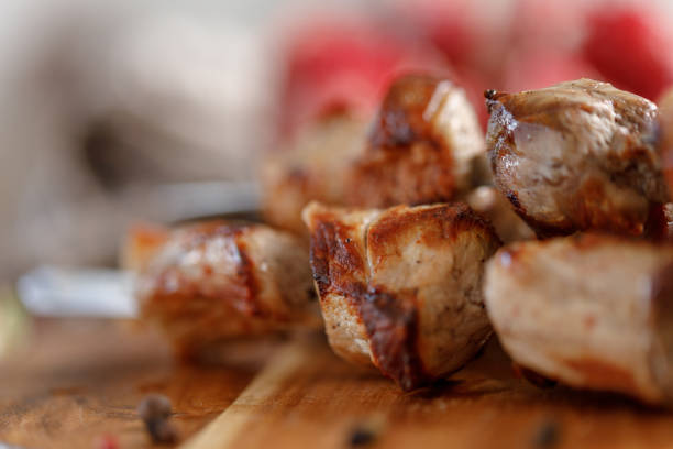 istock Shish kebab from pork closeup. Juicy meat cooked on an open fire. Rustic. 954198076