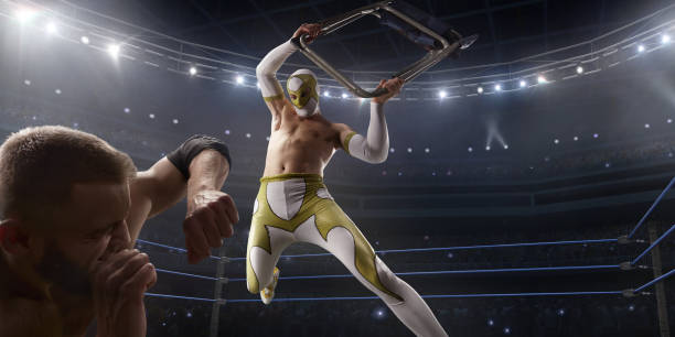Wrestling show. Two wrestlers in a bright sport clothes and face mask fight in the ring Wrestling show. Two wrestlers in a bright sport clothes and face mask fight in professional ring. One athlete strikes the second man with a chair wrestling stock pictures, royalty-free photos & images