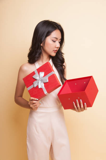 istock Young Asian woman open a gift box. 954198878