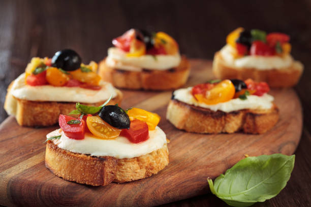 bruschetta with tomatoes and mozzarella. - bruschetta cutting board italy olive oil imagens e fotografias de stock