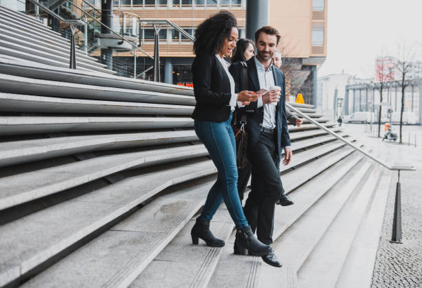 istock Small group of business people walking down the stairs 954204190
