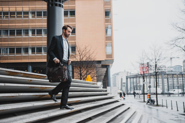 istock Businessman running down the stairs 954204216
