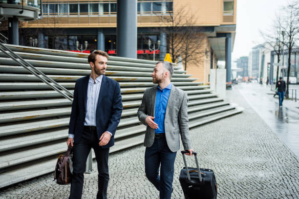 istock Businessmen on the go with suitcases 954204308