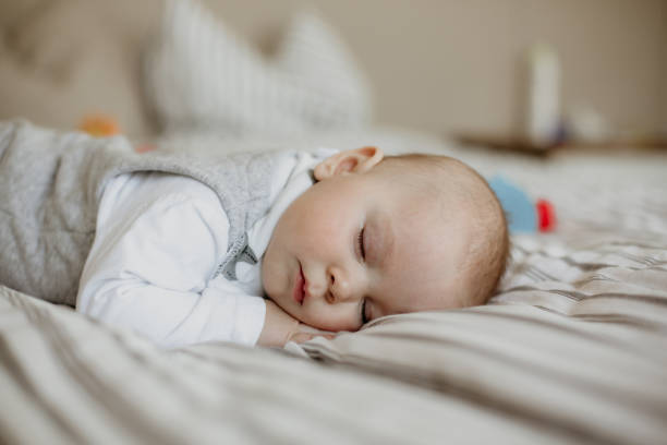 istock Little baby boy, sleeping in big bed in bedroom 954207196