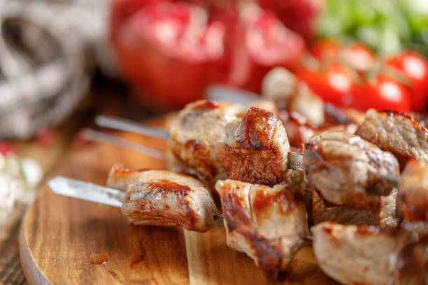 istock Shish kebab from pork closeup. Juicy appetizing meat cooked on an open fire. Rustic. 954211494