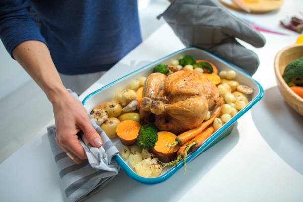 istock Woman carrying thanksgiving turkey 954211680