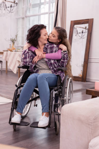 istock Pretty girl adoring disabled woman 954212012