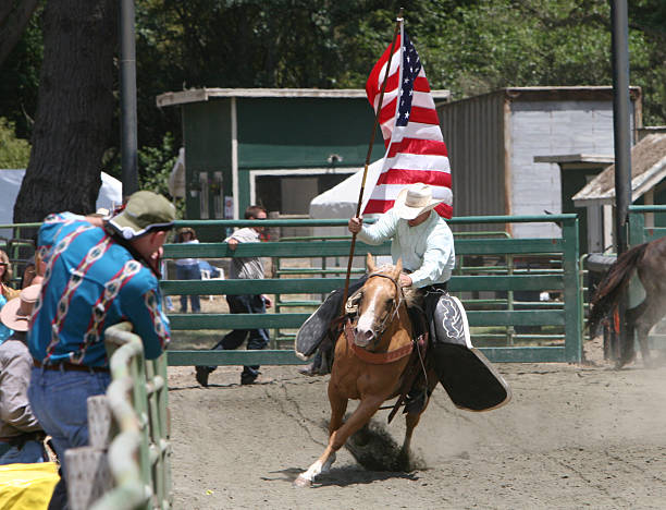 Oaxaca, Mexico - July 09, 2023: Mexican Cowboys riding beautiful horses at the parade in city street, Oaxaca, Mexico