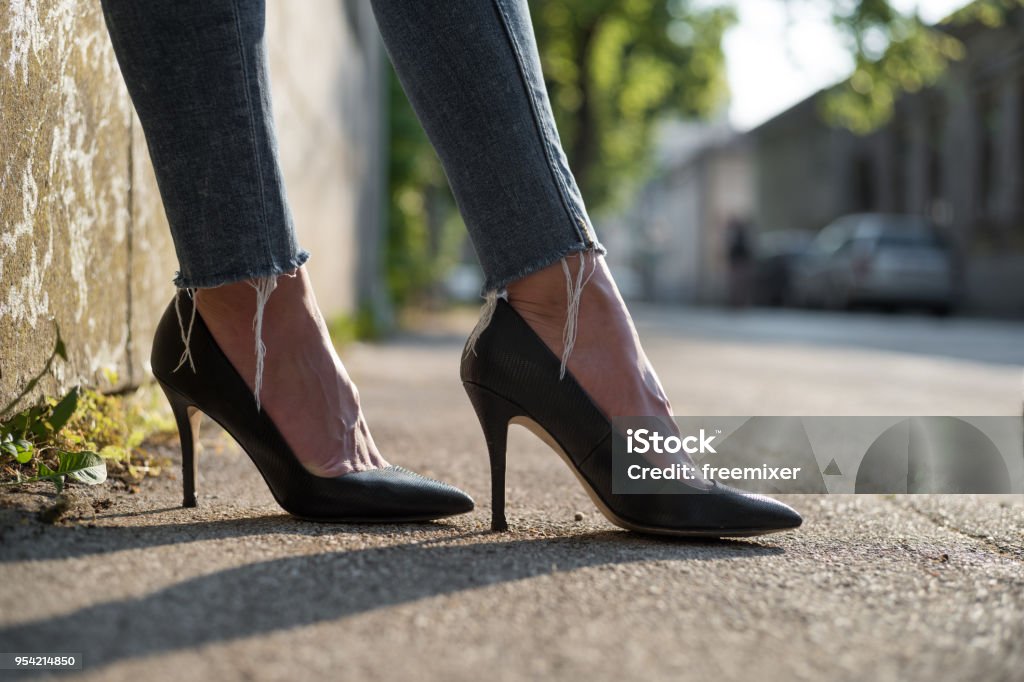 Legs and heels Low angle view on businesswoman's heels on the street High Heels Stock Photo