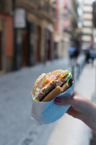 istock SA hand holding a hamburger in hands. Summer 954216104