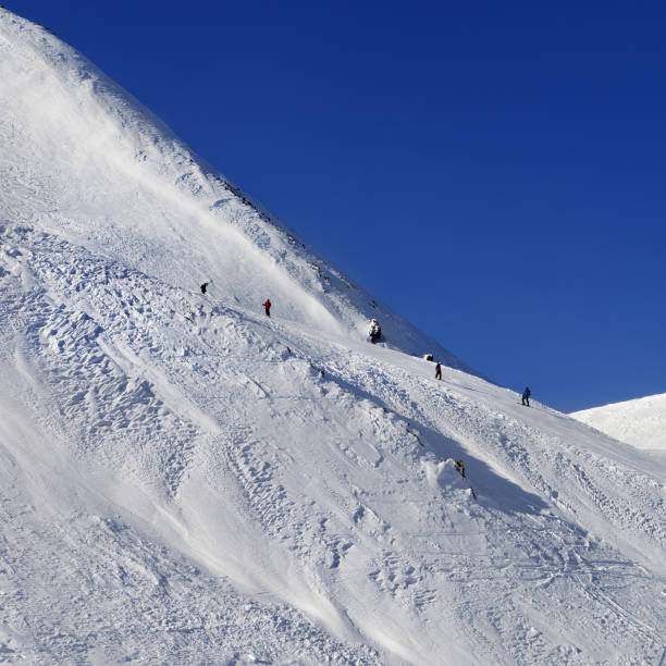 istock Skiers and snowboarders on ski piste 954216488