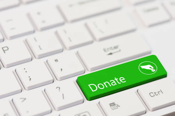 green key with text Donate on white laptop keyboard