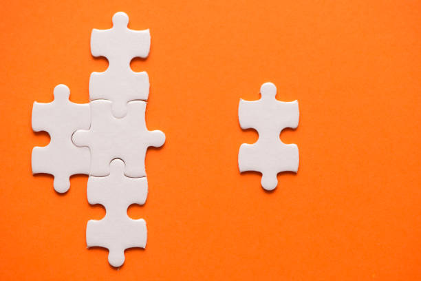 istock White details of puzzle on orange background 954221188