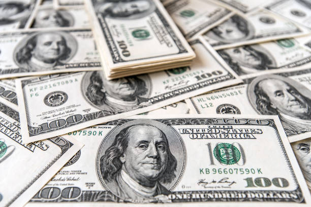 istock Close Up of Stack of dollars as background 954221290