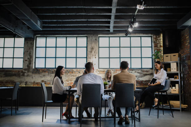 Leading team is inspiring and rewarding. Group of people having meeting at modern office market research photos stock pictures, royalty-free photos & images
