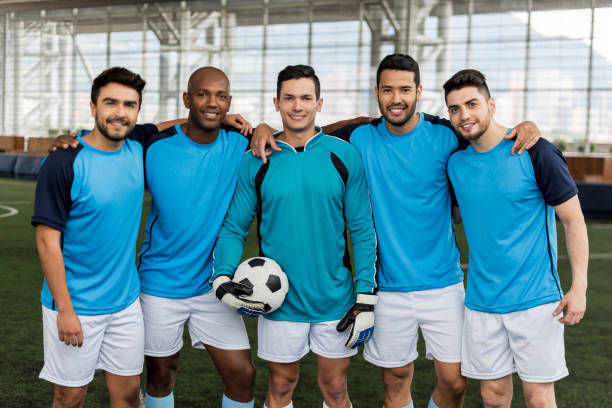 istock Cheerful professional soccer players looking at camera smiling 954226676