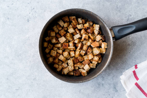 istock Healthy Organic Crispy Croutons Fried in Pan. 954229180